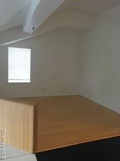 a view of wooden floor and a window