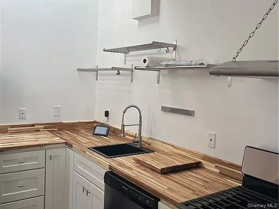 a view of a kitchen with a sink and cabinets