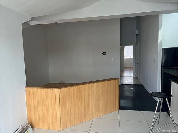 1418 Outlook Avenue, Unit 3 Bronx, NY 10465 - Photo 9 of 9 a view of a room with wooden floor and staircase