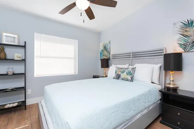 a bedroom with a bed and a flat tv screen on the dresser