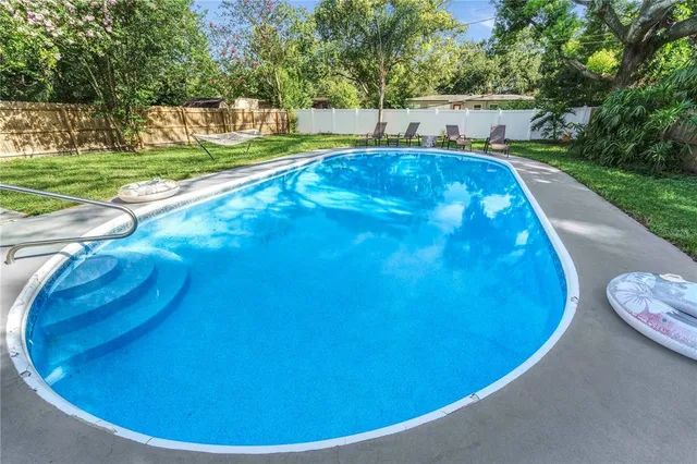 a view of a swimming pool with a patio