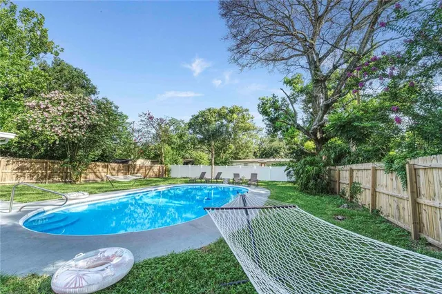 a view of a backyard with sitting area