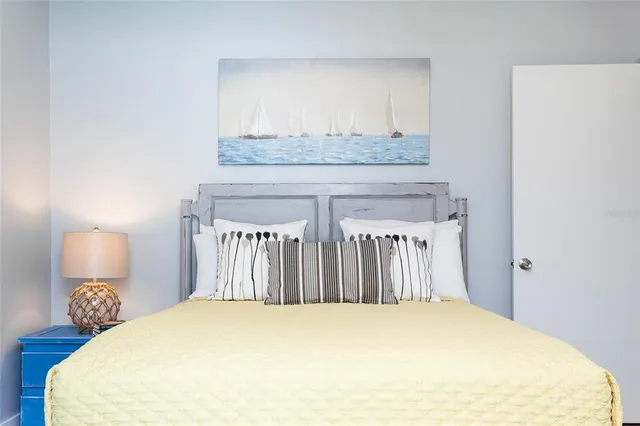 a bedroom with a bed and lamp