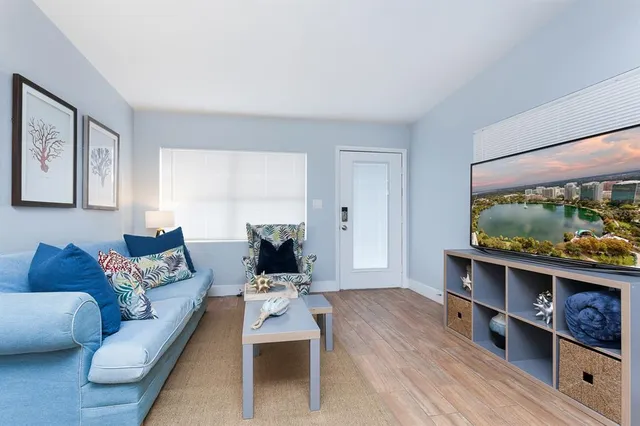 a living room with furniture and a flat screen tv