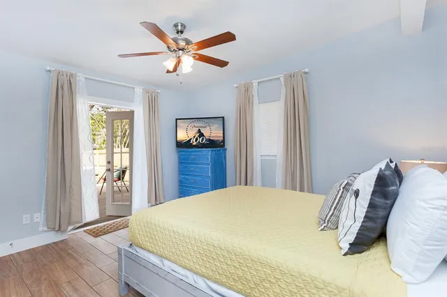 a bed sitting in a bedroom next to a window