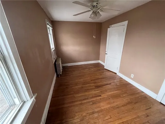 wooden floor in an empty room with a mirror