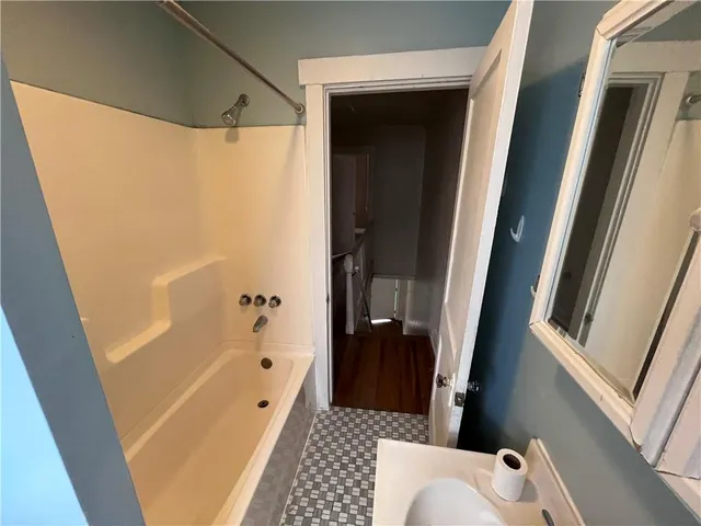 a bathroom with a bathtub and a shower