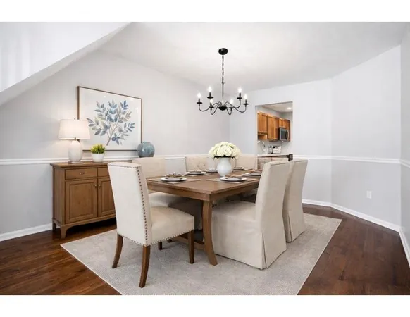 a dining room with furniture and chandelier