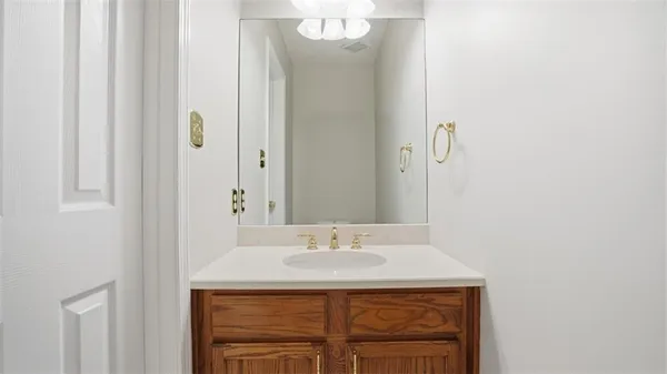 a bathroom with a granite countertop sink a mirror and a vanity