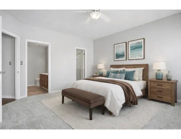 a spacious bedroom with a bed and a chandelier