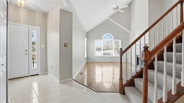 a view of entryway and hall with wooden floor