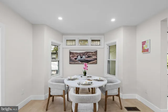 a view of a dining room with furniture window and wooden floor