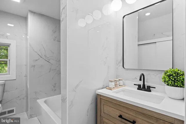 a bathroom with a sink a vanity and a mirror