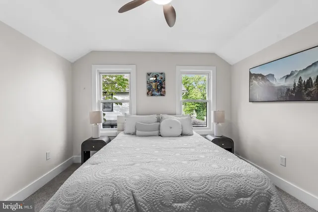 a bedroom with a large bed and a window