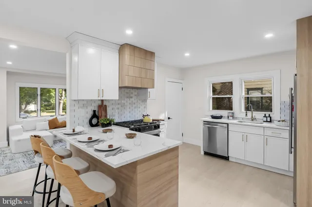 a kitchen that has a sink and a stove in it