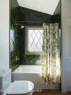 a bathroom with a sink a mirror and a shower