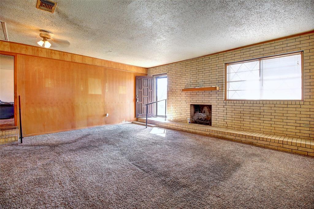 512 North Sherley Road Anna, TX 75409 - Photo 5 of 20 an empty room with fireplace and windows