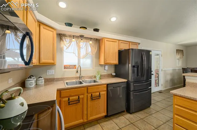 a kitchen with a sink appliances and cabinets