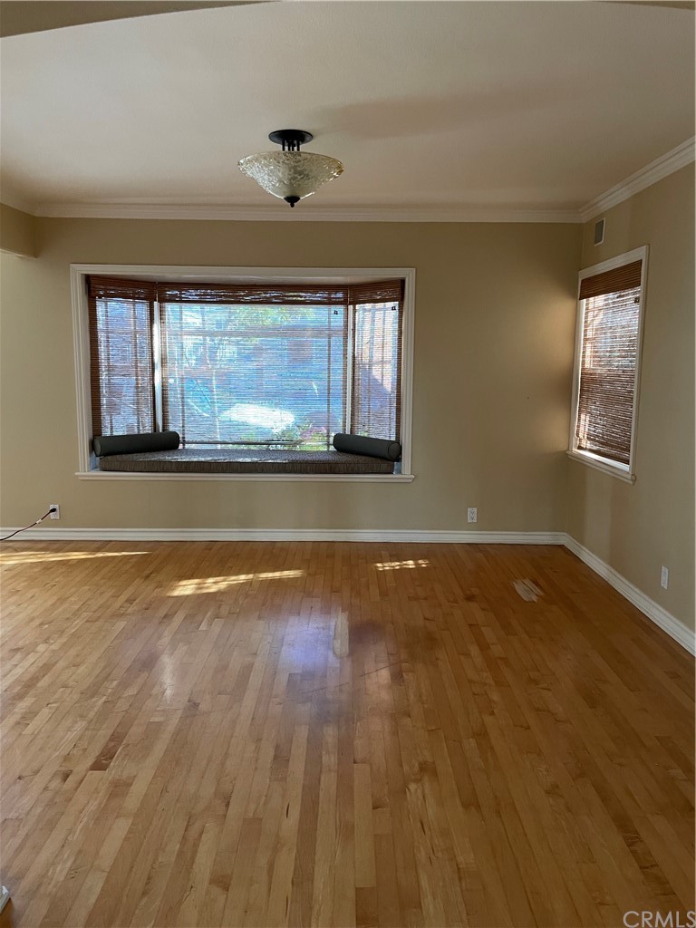 239 16th Street Seal Beach, CA 90740 - Photo 5 of 11 a view of empty room with wooden floor and fan