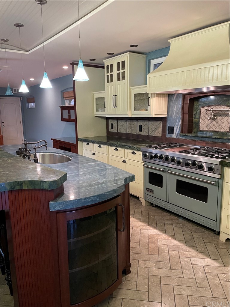 239 16th Street Seal Beach, CA 90740 - Photo 6 of 11 a kitchen with a stove and a sink
