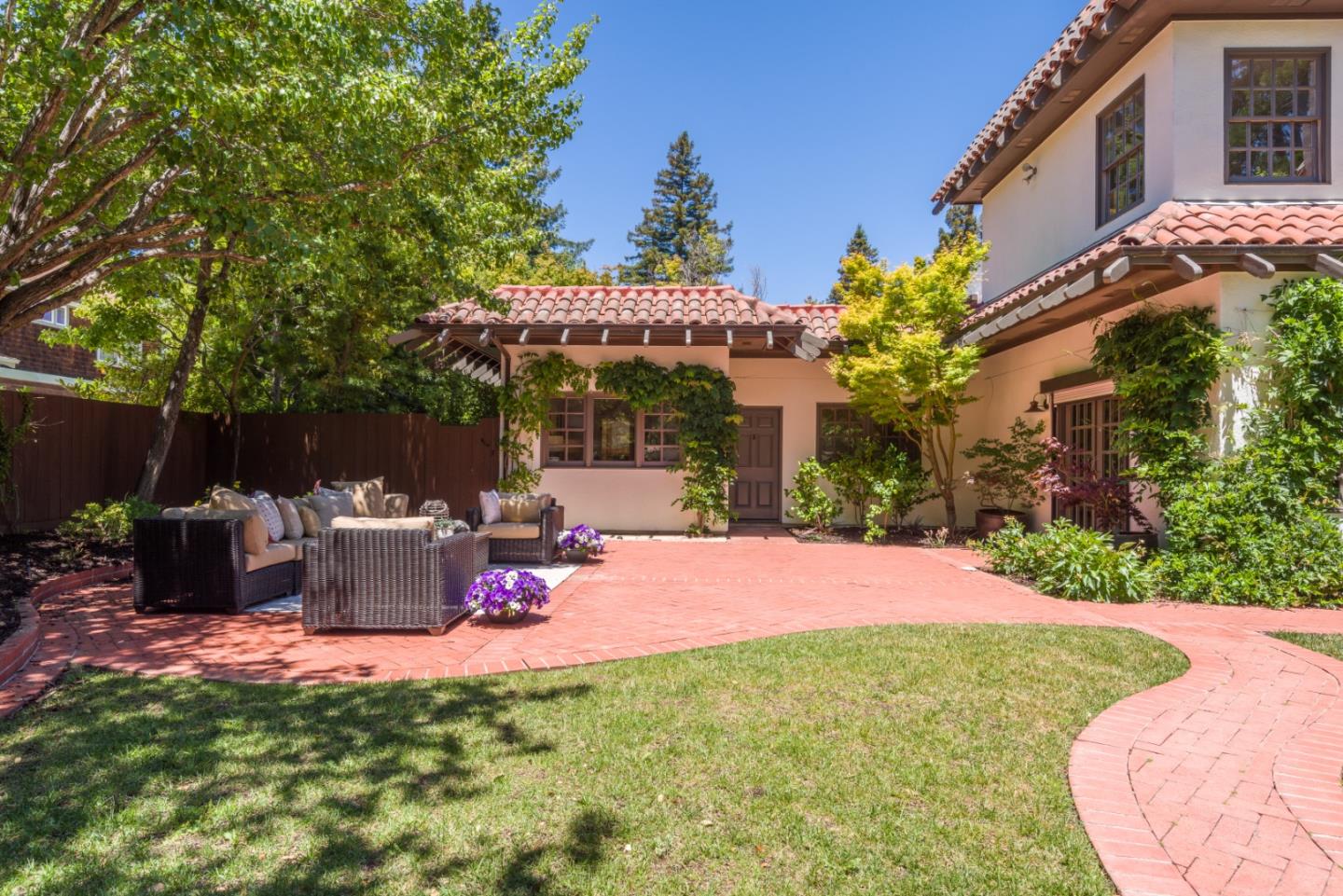 400 Warren Road San Mateo, CA 94402 - Photo 11 of 54 a view of a patio with table and chairs potted plants and large tree