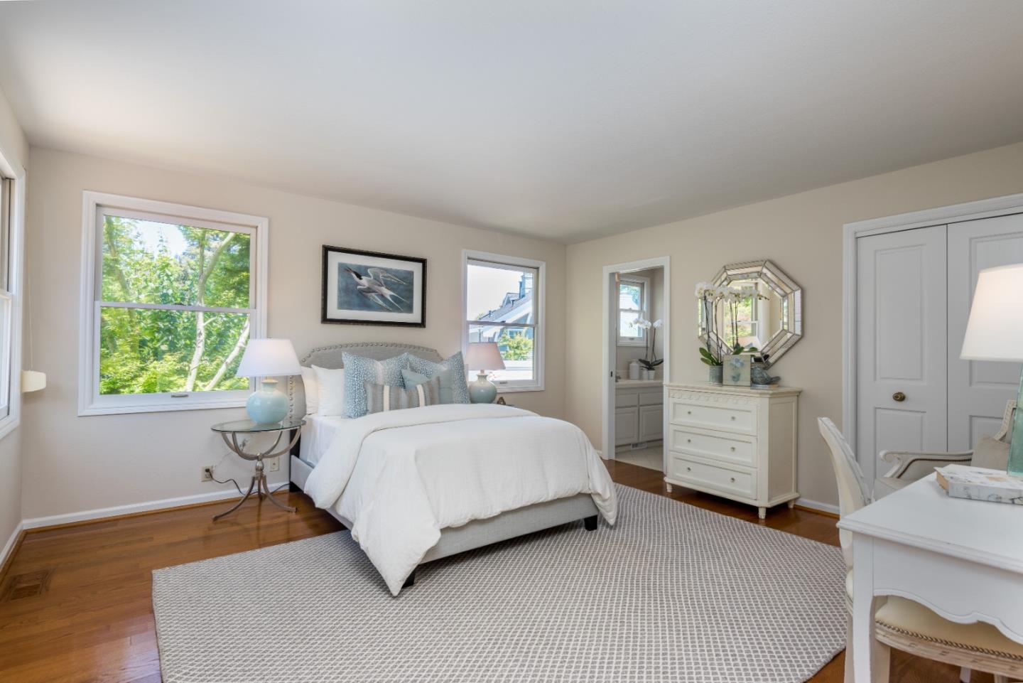 400 Warren Road San Mateo, CA 94402 - Photo 20 of 54 a spacious bedroom with a bed a dresser and window