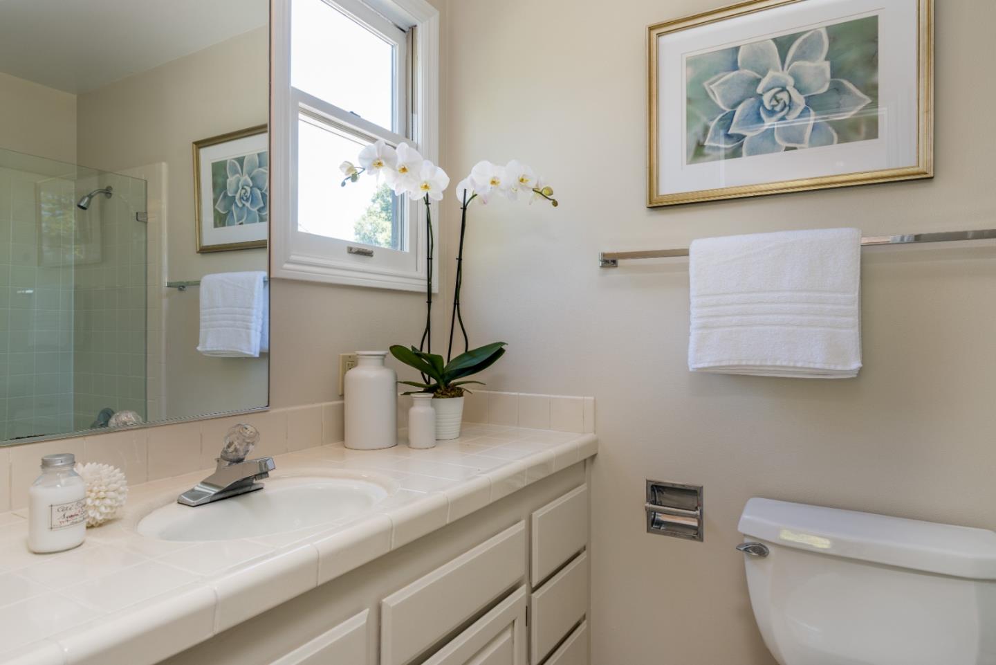 400 Warren Road San Mateo, CA 94402 - Photo 21 of 54 a bathroom with a sink a mirror and a toilet