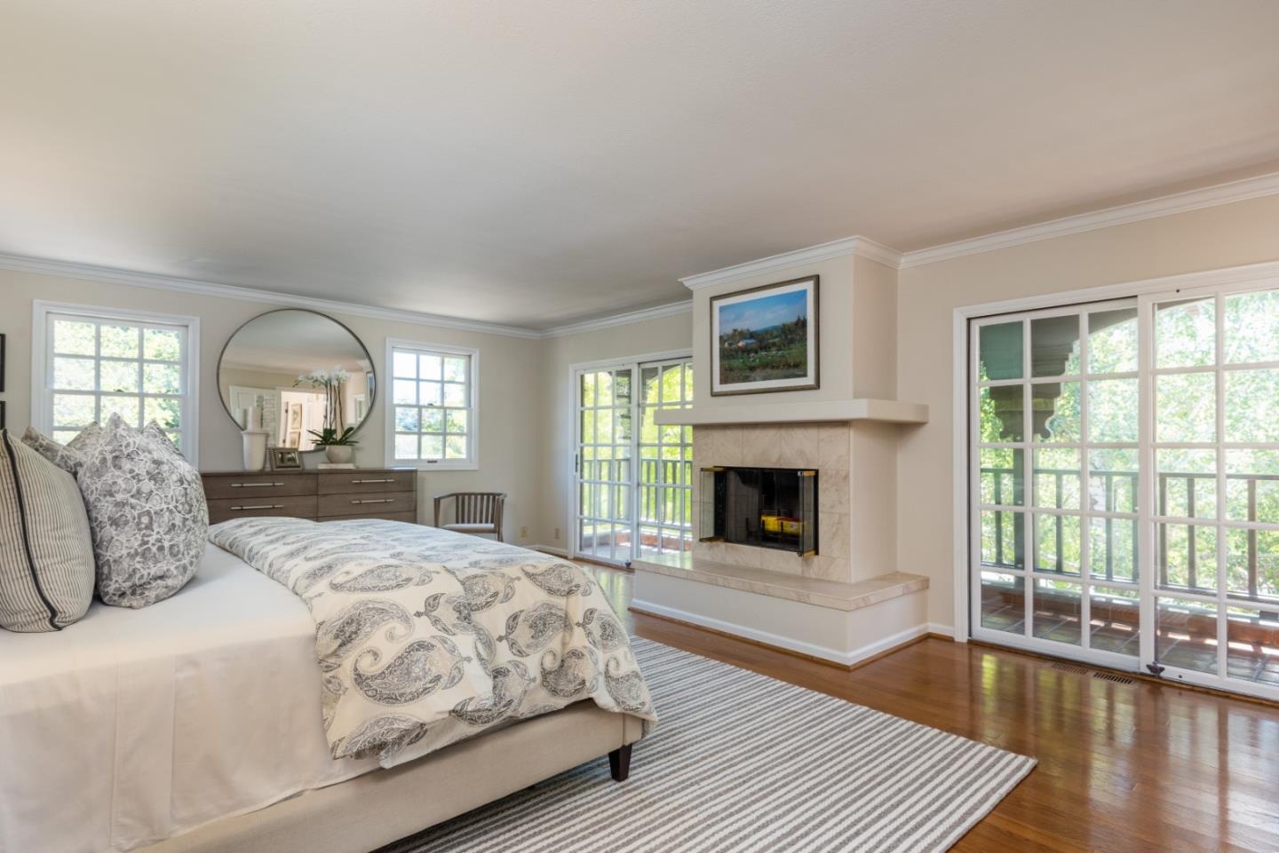 400 Warren Road San Mateo, CA 94402 - Photo 22 of 54 a bedroom with a large bed and a fireplace