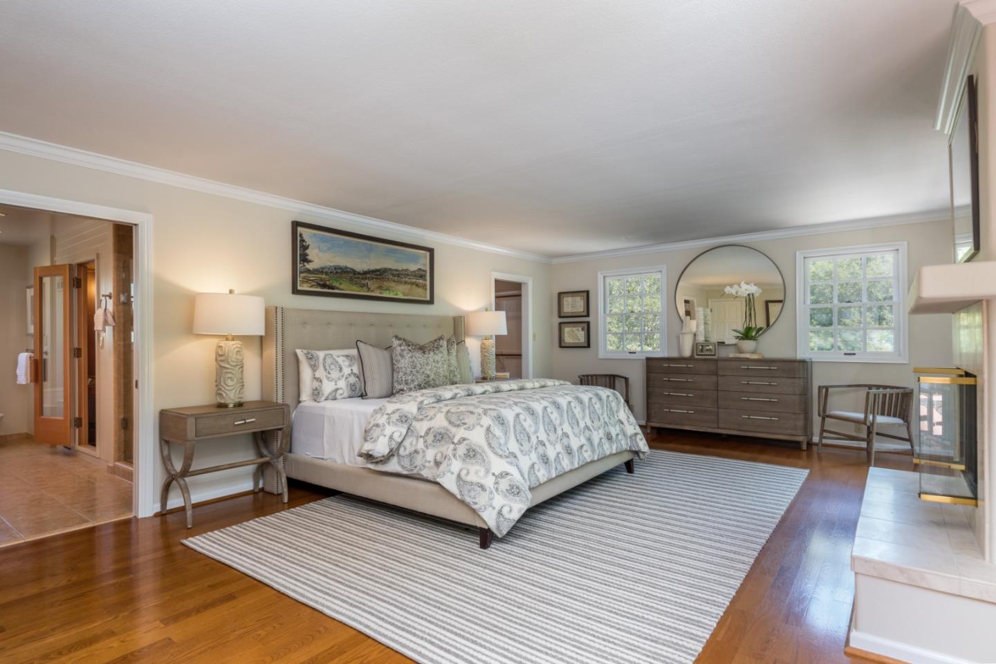 400 Warren Road San Mateo, CA 94402 - Photo 23 of 54 a bedroom with a bed a dresser with wooden floor