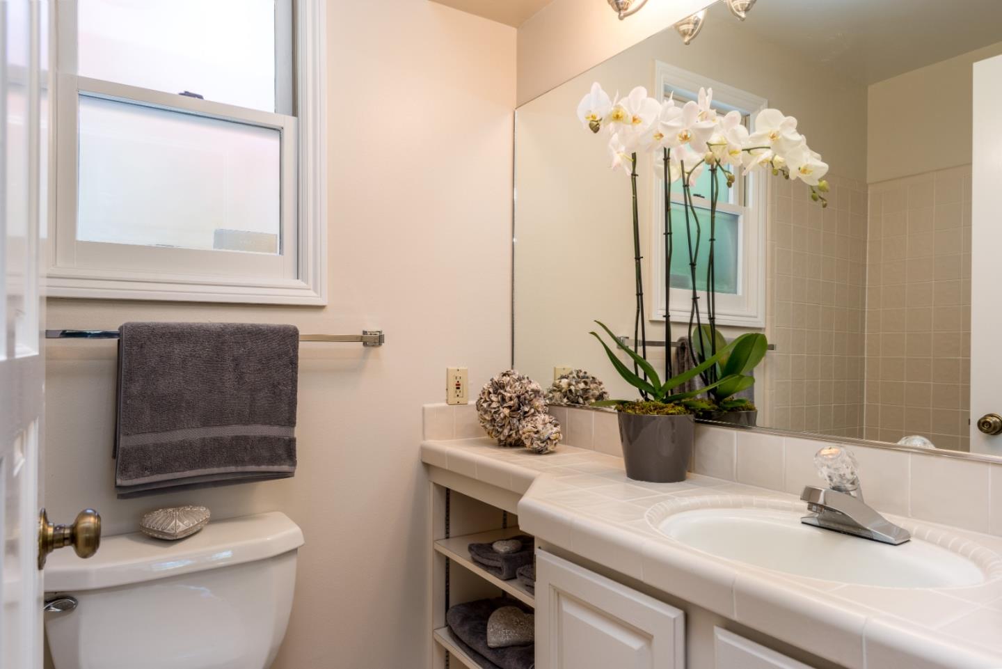 400 Warren Road San Mateo, CA 94402 - Photo 30 of 54 a bathroom with a sink a toilet and a mirror