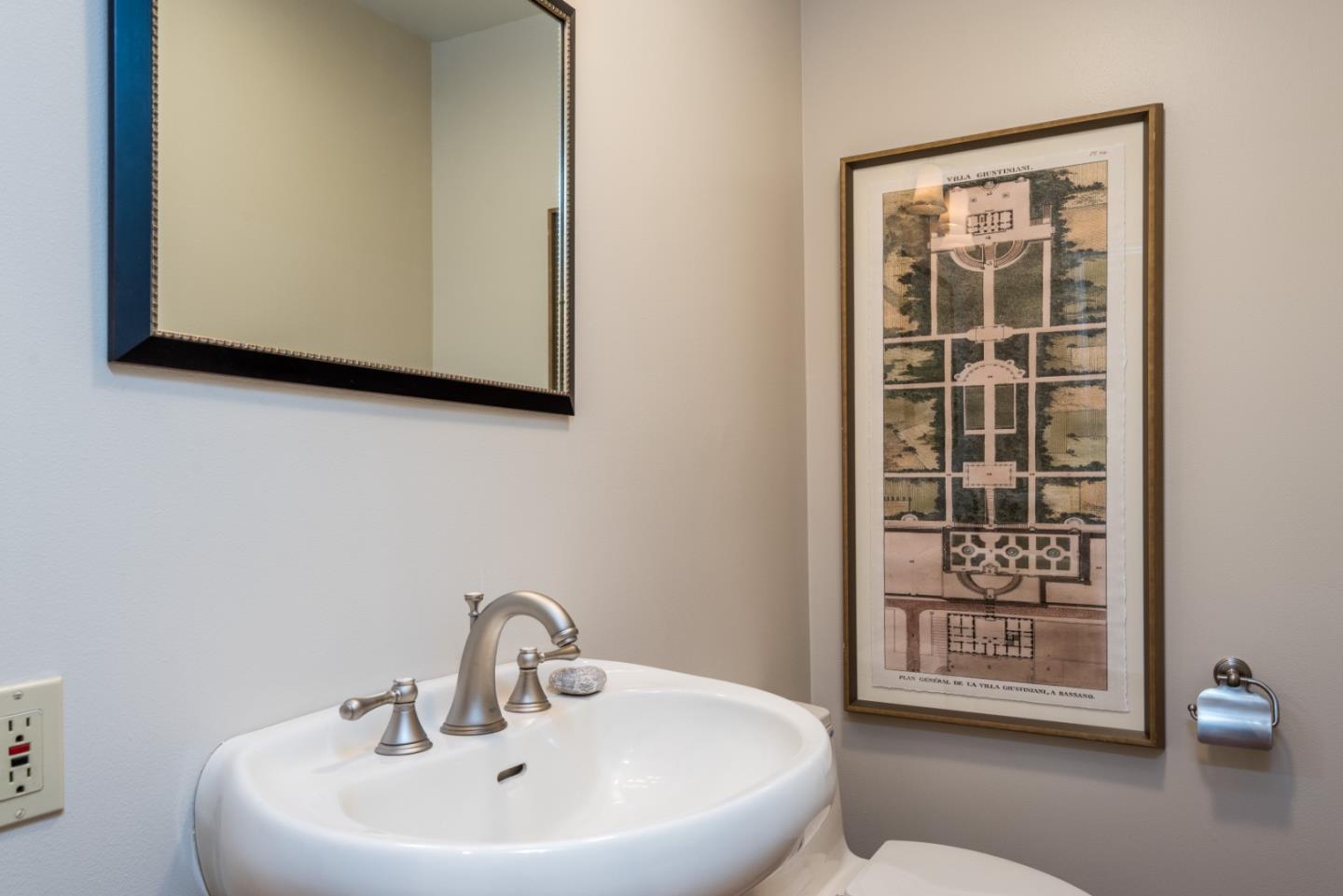 400 Warren Road San Mateo, CA 94402 - Photo 32 of 54 a bathroom with a sink a mirror and a window