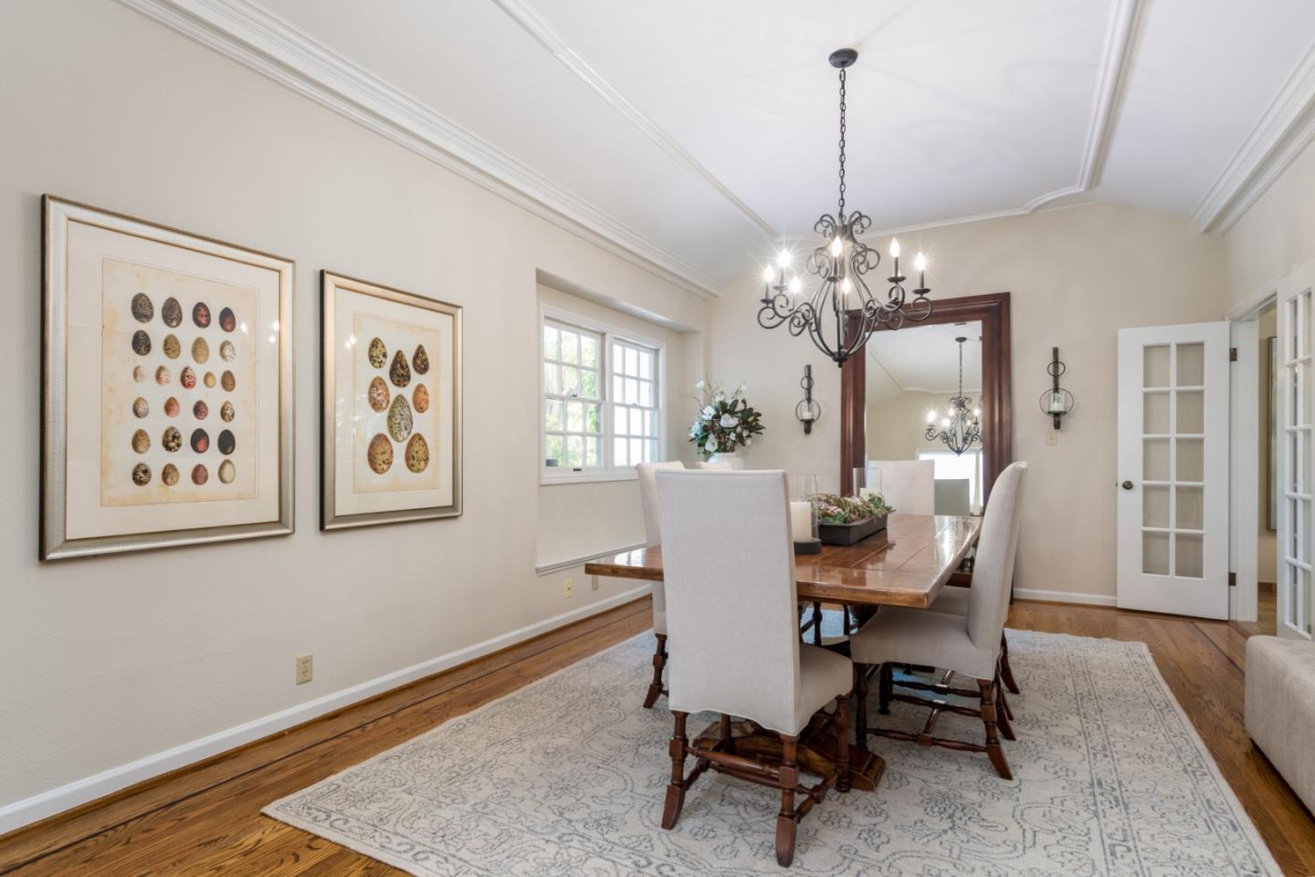 400 Warren Road San Mateo, CA 94402 - Photo 39 of 54 a dining room with wooden floor and a chandelier