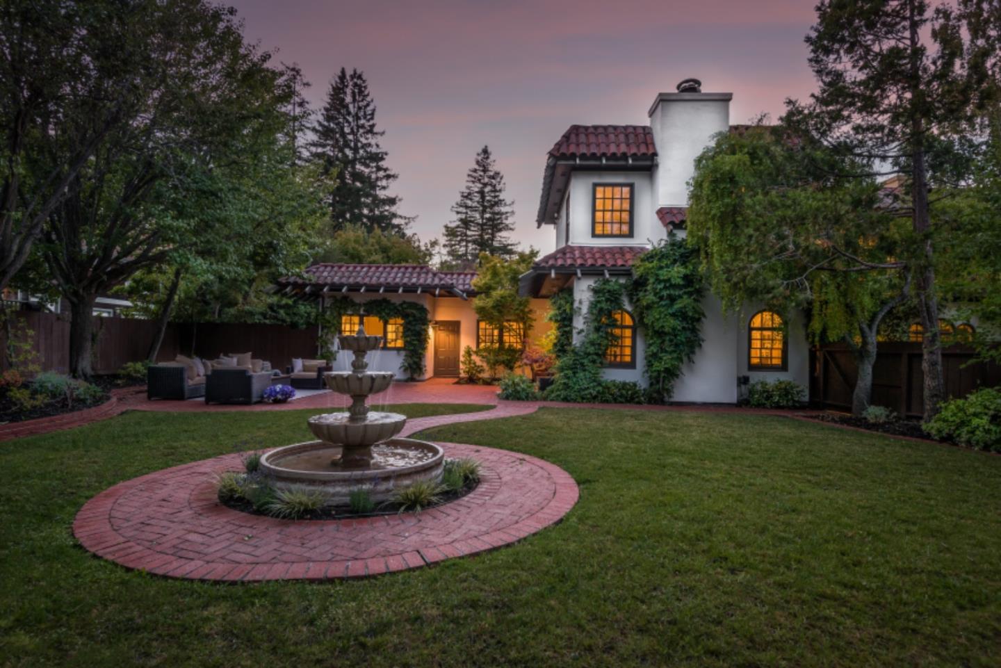 400 Warren Road San Mateo, CA 94402 - Photo 49 of 54 a front view of a house with a yard fire pit and outdoor seating