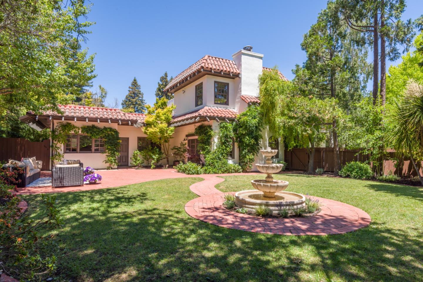 400 Warren Road San Mateo, CA 94402 - Photo 5 of 54 a view of a backyard with table and chairs under an umbrella