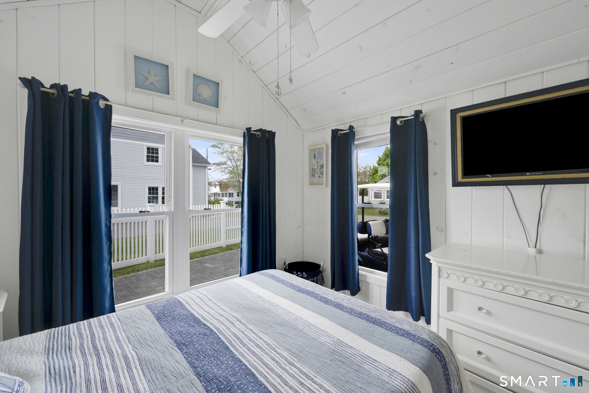 96 Chalker Beach Road Old Saybrook, CT 06475 - Photo 28 of 33 a bedroom with a bed and a flat screen tv