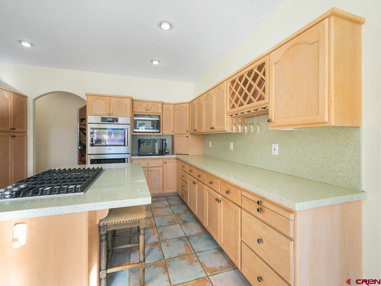 895 24 1/2 Road Grand Junction, CO 81505 - Photo 12 of 42 a kitchen with stainless steel appliances a stove a sink and a cabinets