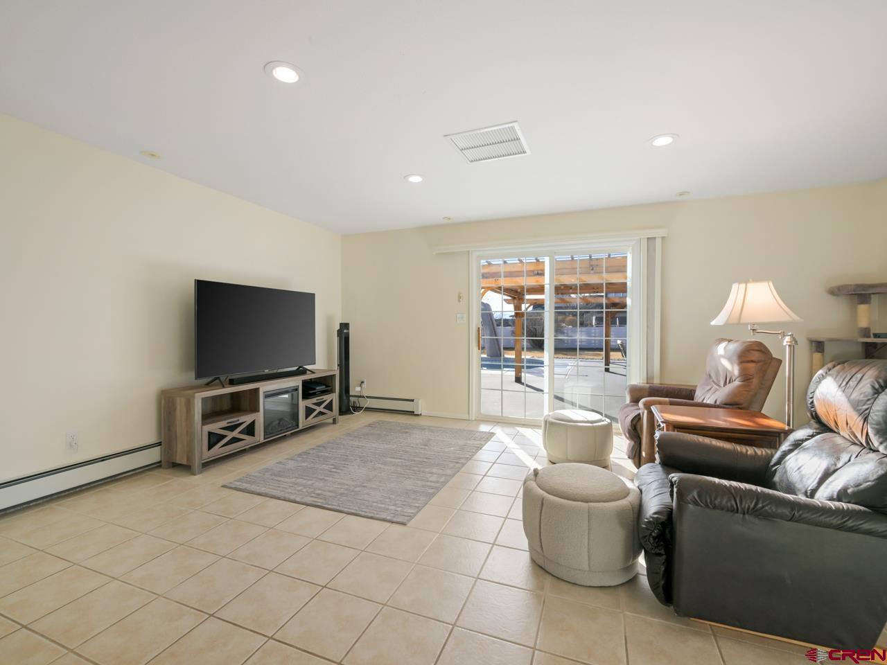 895 24 1/2 Road Grand Junction, CO 81505 - Photo 21 of 42 a living room with furniture and a flat screen tv
