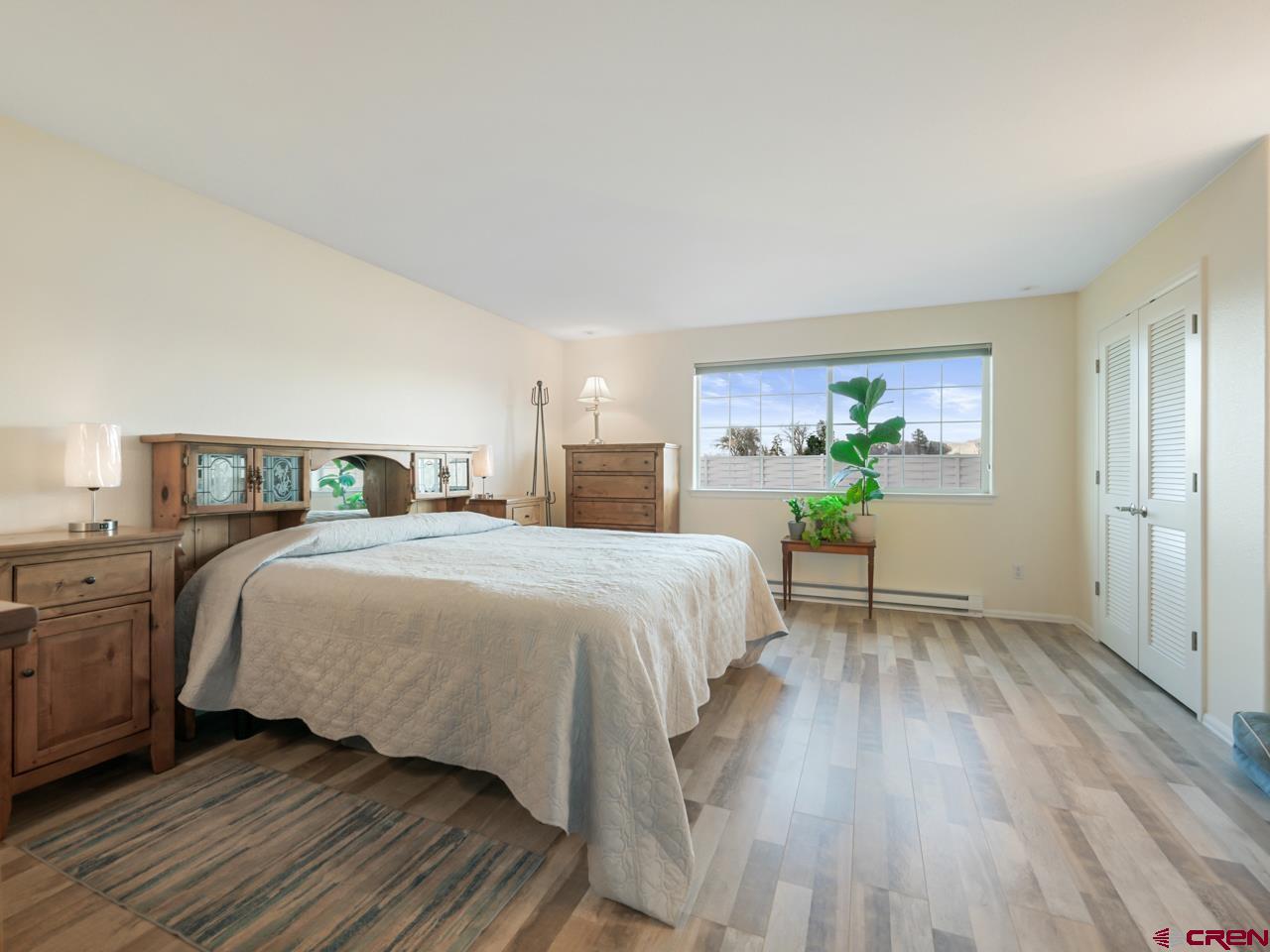 895 24 1/2 Road Grand Junction, CO 81505 - Photo 23 of 42 a bedroom with a bed and wooden floor