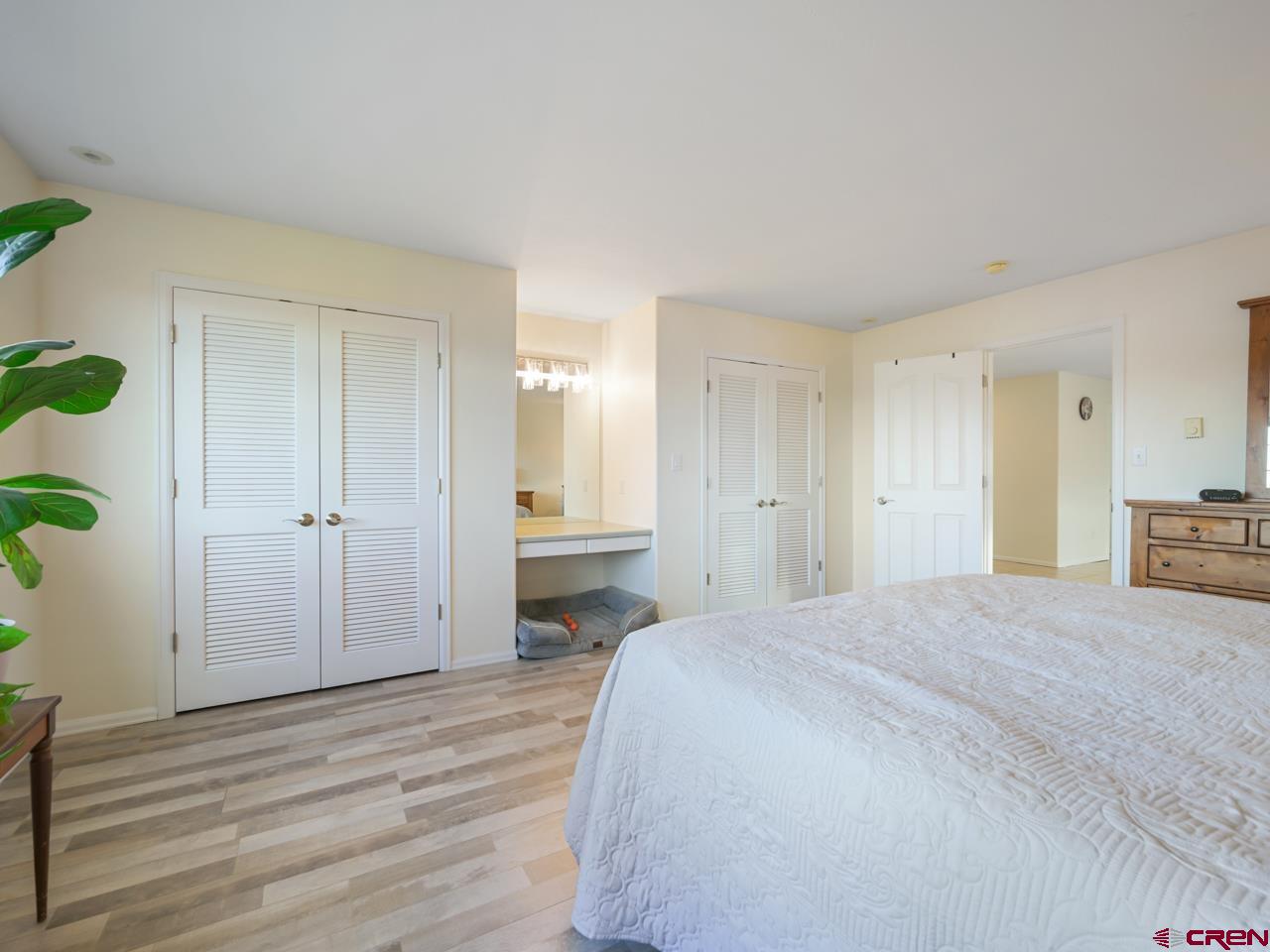 895 24 1/2 Road Grand Junction, CO 81505 - Photo 25 of 42 a spacious bedroom with a bed and a wooden floor