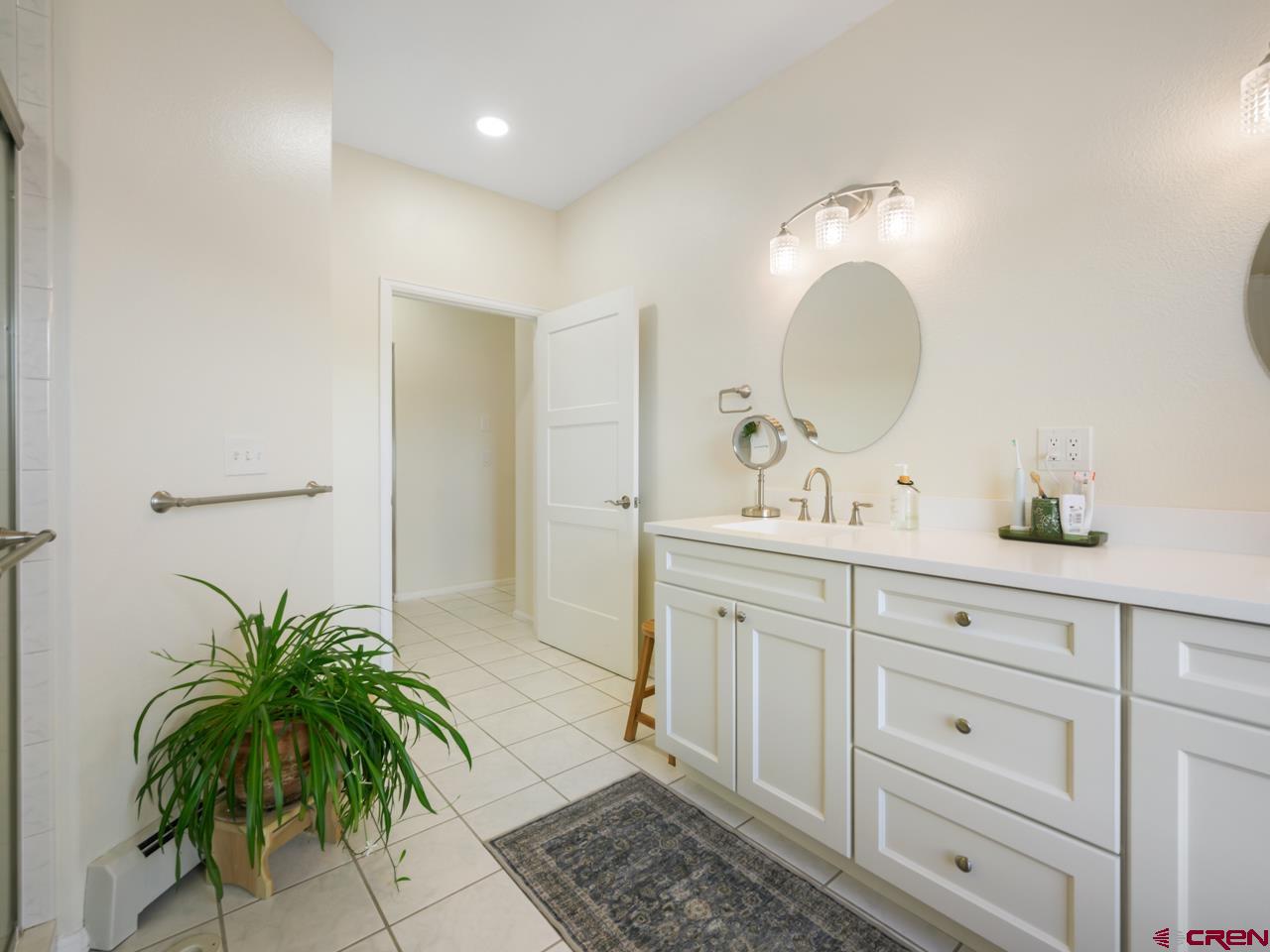 895 24 1/2 Road Grand Junction, CO 81505 - Photo 30 of 42 a bathroom with a double vanity sink and a mirror