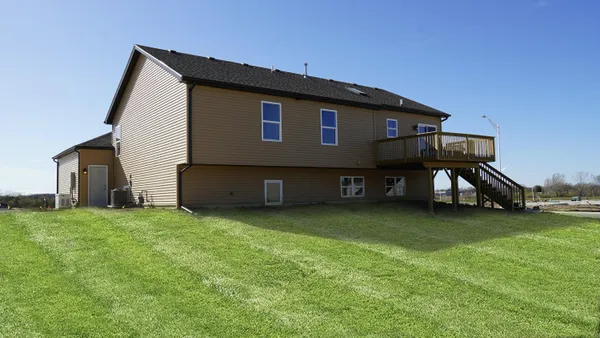 a house that has a big yard with wooden fence