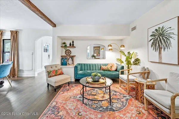 a living room with furniture and a dining table