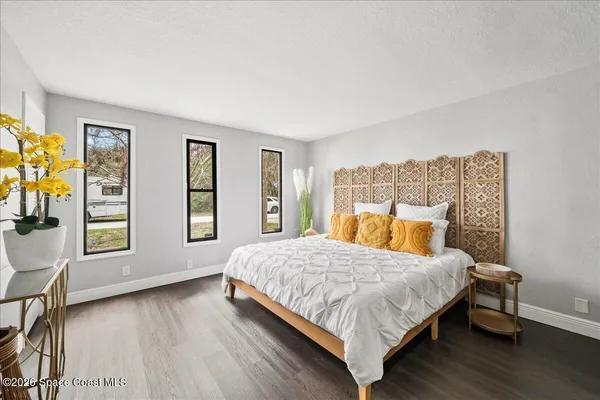 a bedroom with a bed and a couch
