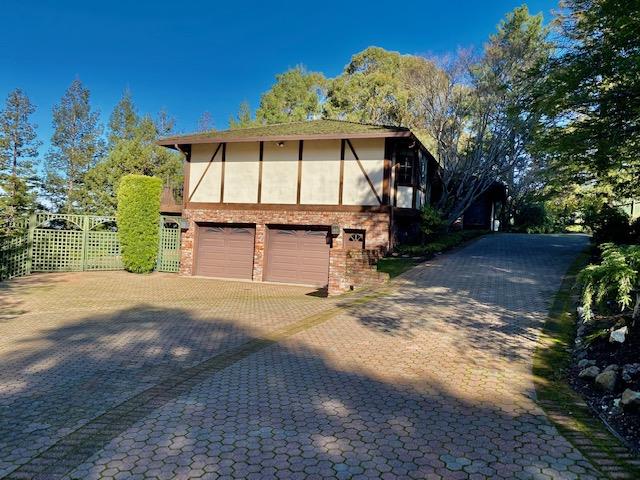 1300 La Honda Road Hillsborough, CA 94010 - Photo 3 of 17 a front view of a house with a garden