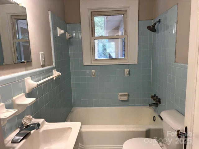 a bathroom with a bathtub and toilet