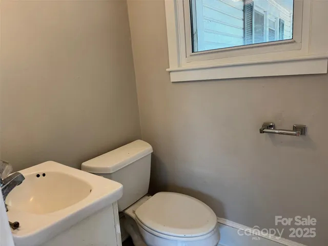 a white toilet sitting next to a bathroom sink