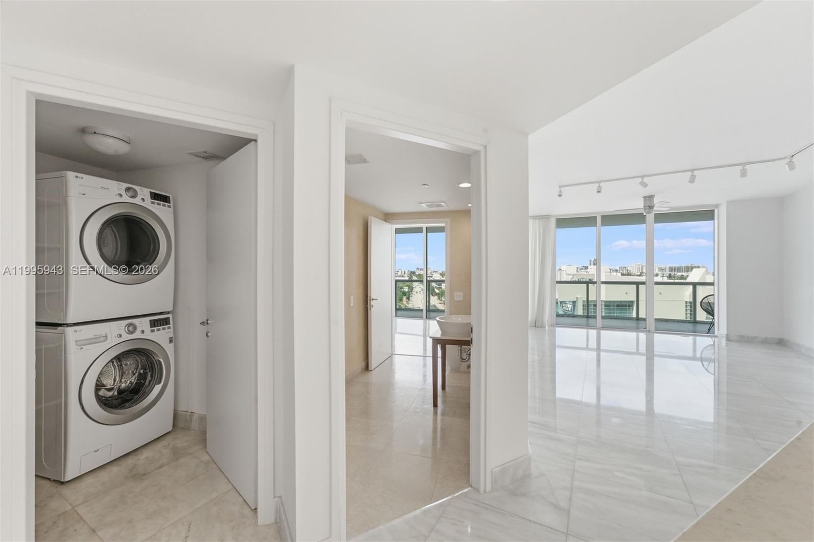 450 Alton Road, Unit 910 Miami Beach, FL 33139 - Photo 6 of 59 a view of a hallway with washer and dryer