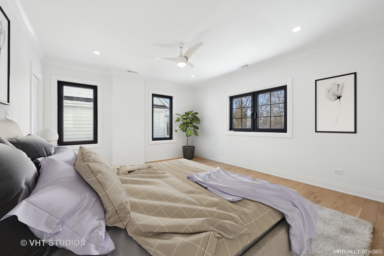 399 Ridge Avenue Winnetka, IL 60093 - Photo 20 of 45 a bedroom with a large bed and a chandelier