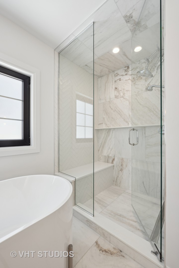 399 Ridge Avenue Winnetka, IL 60093 - Photo 23 of 45 a bathroom with a bathtub and a shower