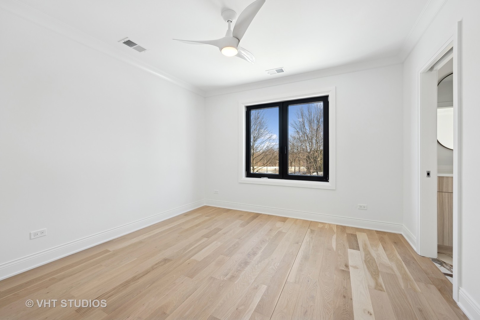 399 Ridge Avenue Winnetka, IL 60093 - Photo 29 of 45 wooden floor in an empty room with a window